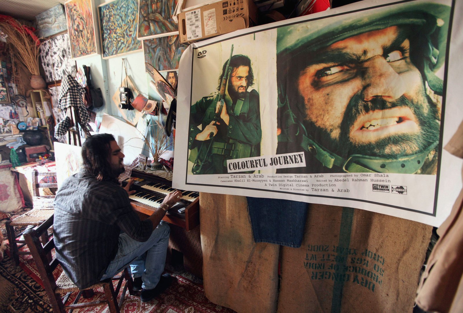 Palestinian actor and artist Ahmed Abu Nasser, 23, better known locally by his nickname Tarzan, plays the electric piano at his family house in northern Gaza Strip December 28, 2010. Abu Nasser and his twin brother Mohammed (not seen) won a local competit